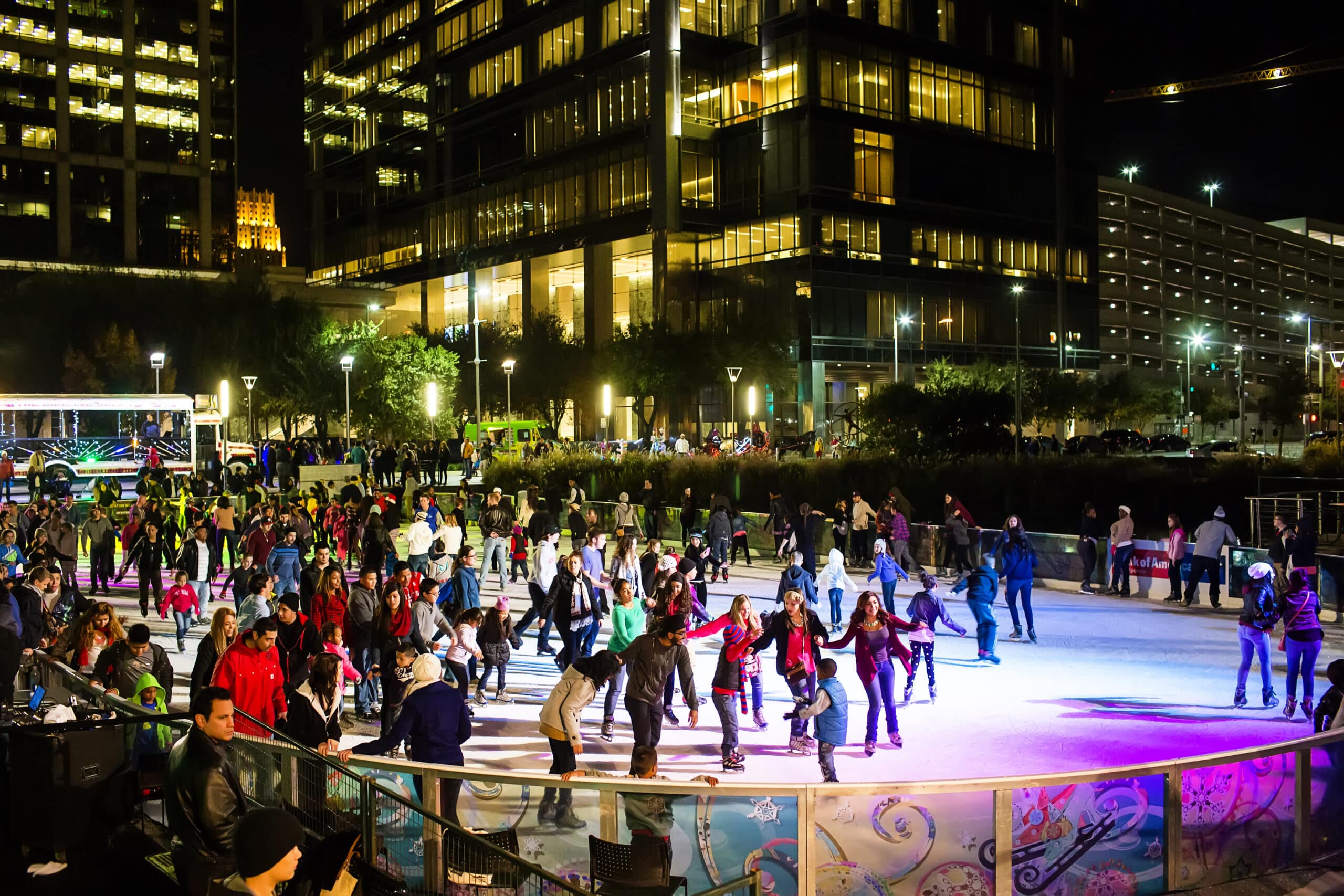 Ice skating to music played by DJ at Discovery Green downtown Houston.