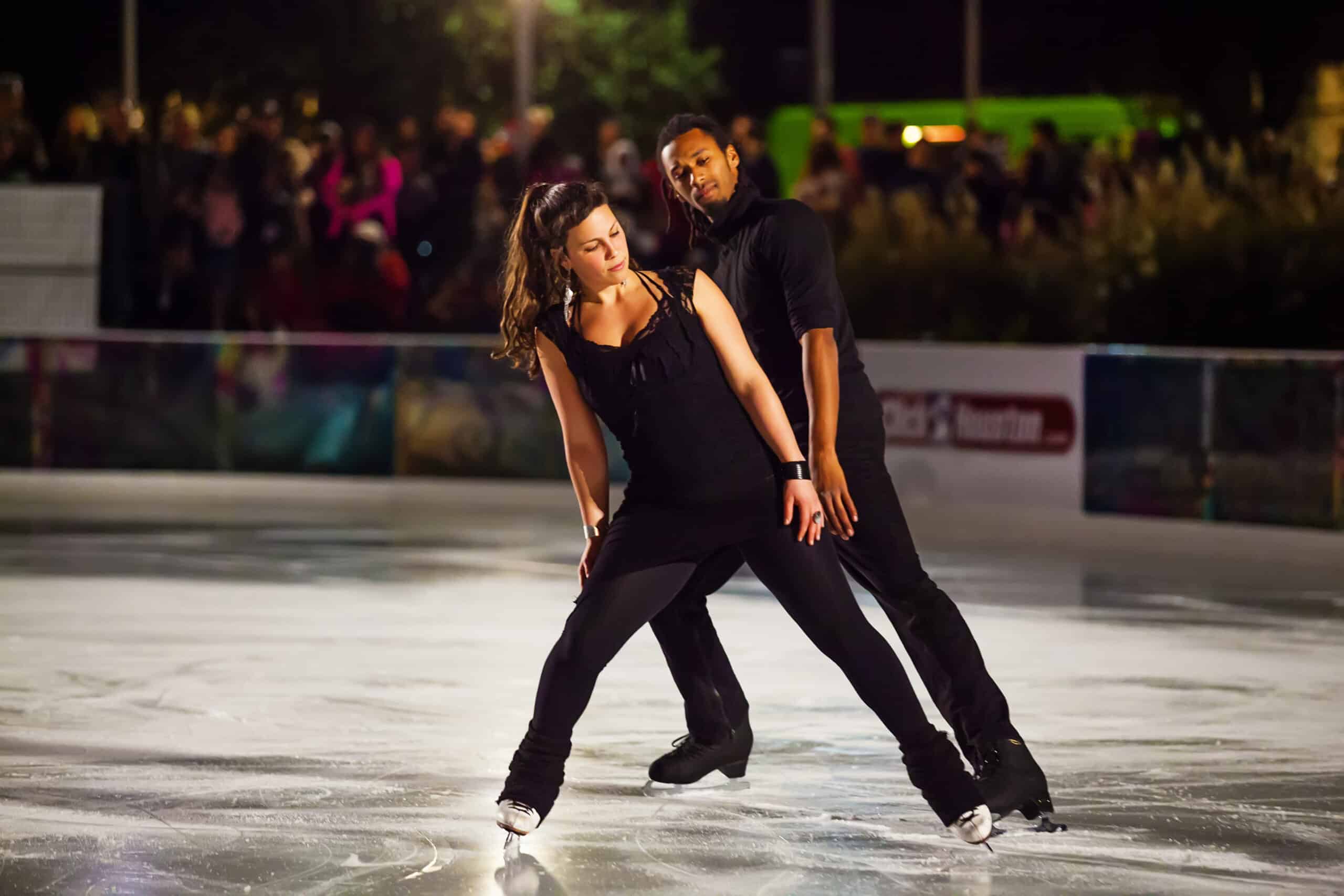 Figure ice skaters perform at the ice rink downtown Houston, Discovery Green.